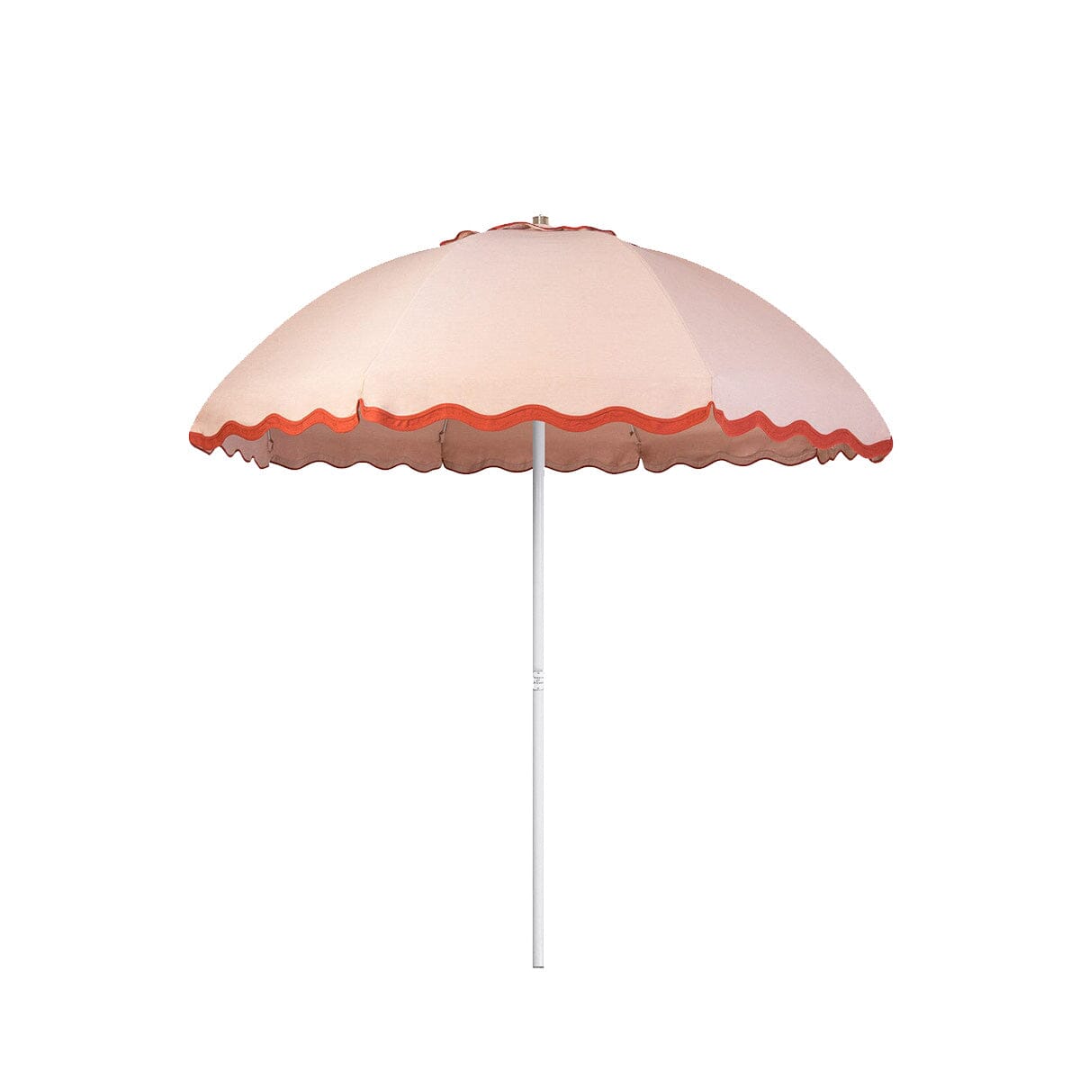 Business & Pleasure Co. Patio Umbrella in Rivie Pink, featuring a dome-shaped blush pink canopy with scalloped edges, contrasting terracotta red wave trim and a white center pole.