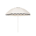 Business & Pleasure Co. Patio Umbrella in Rivie White, featuring a dome-shaped ivory canopy with scalloped edges, contrasting dark navy wave trim and a white center pole.**