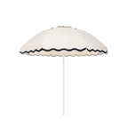 Business & Pleasure Co. Patio Umbrella in Rivie White, featuring a dome-shaped ivory canopy with scalloped edges, contrasting dark navy wave trim and a white center pole.**