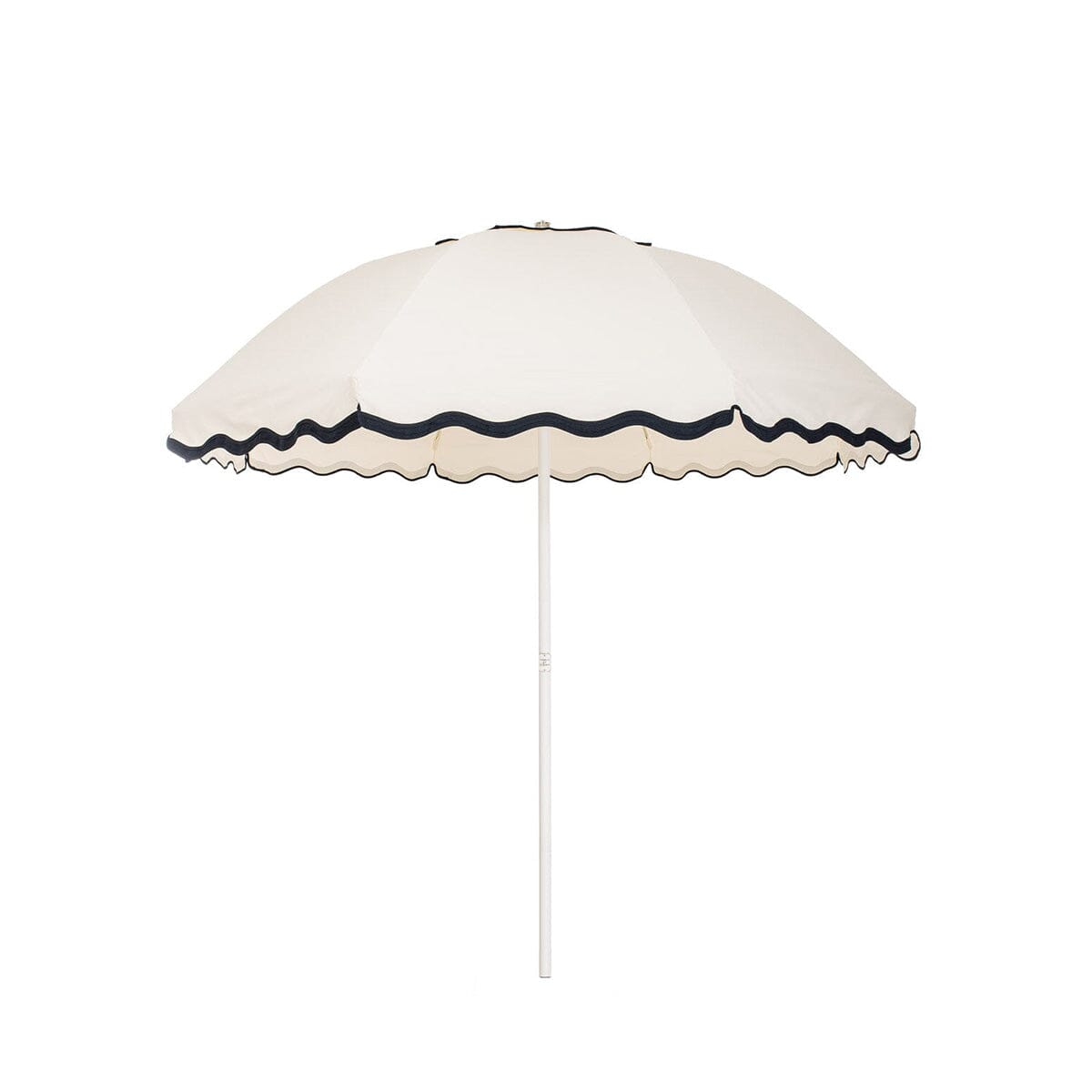 Business & Pleasure Co. Patio Umbrella in Rivie White, featuring a dome-shaped ivory canopy with scalloped edges, contrasting dark navy wave trim and a white center pole.**