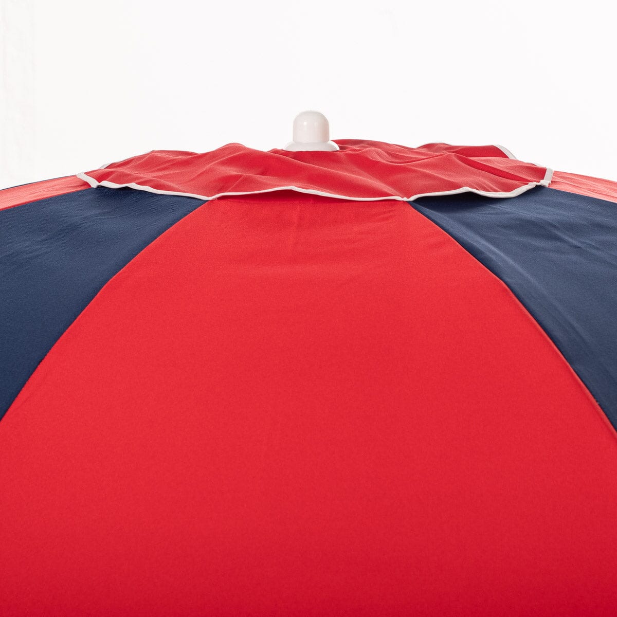Red and navy beach umbrella on a white background