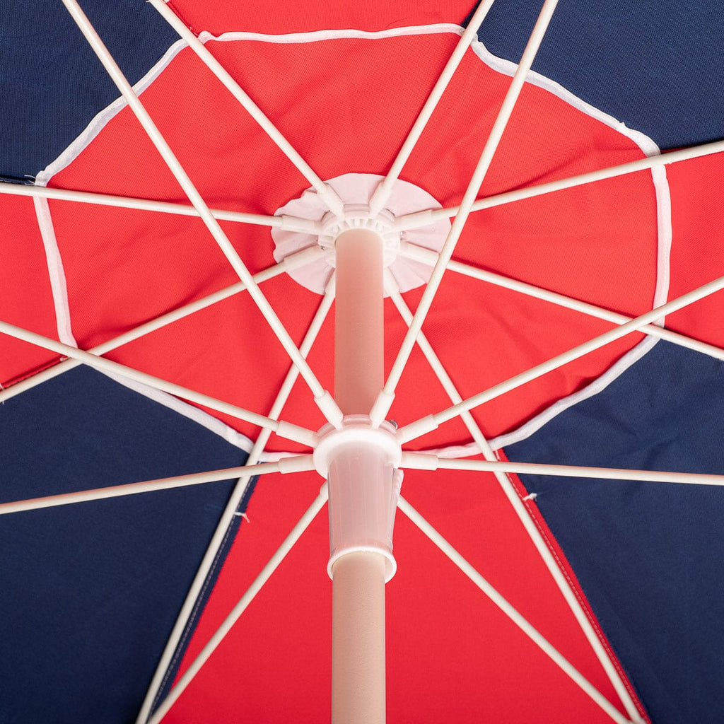Red and navy beach umbrella on a white background
