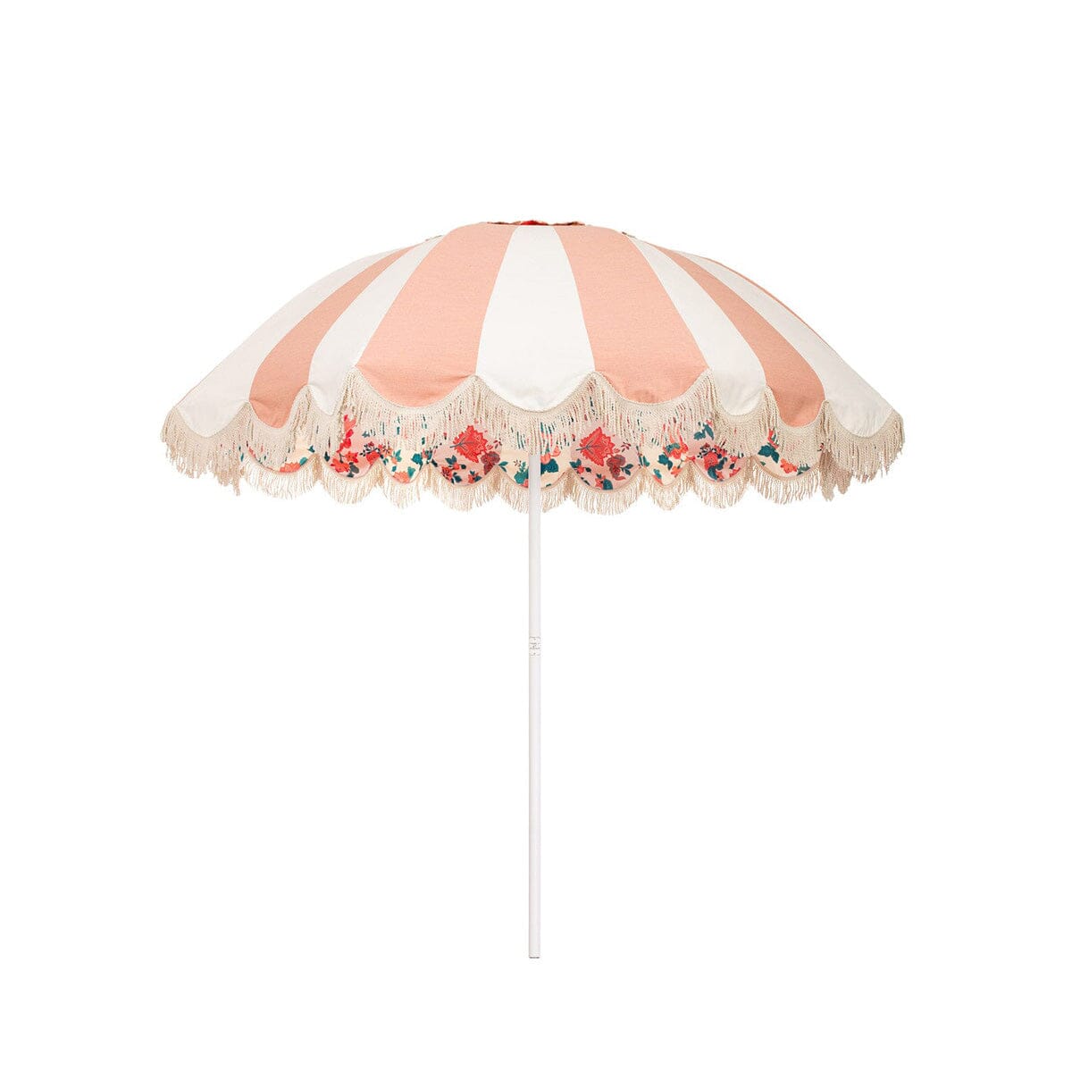 Business & Pleasure Co. Patio Umbrella in Palm Royal, featuring a dome-shaped canopy with alternating blush pink and white panels, scalloped edges, cream fringe, a colorful floral underside and a white center pole.