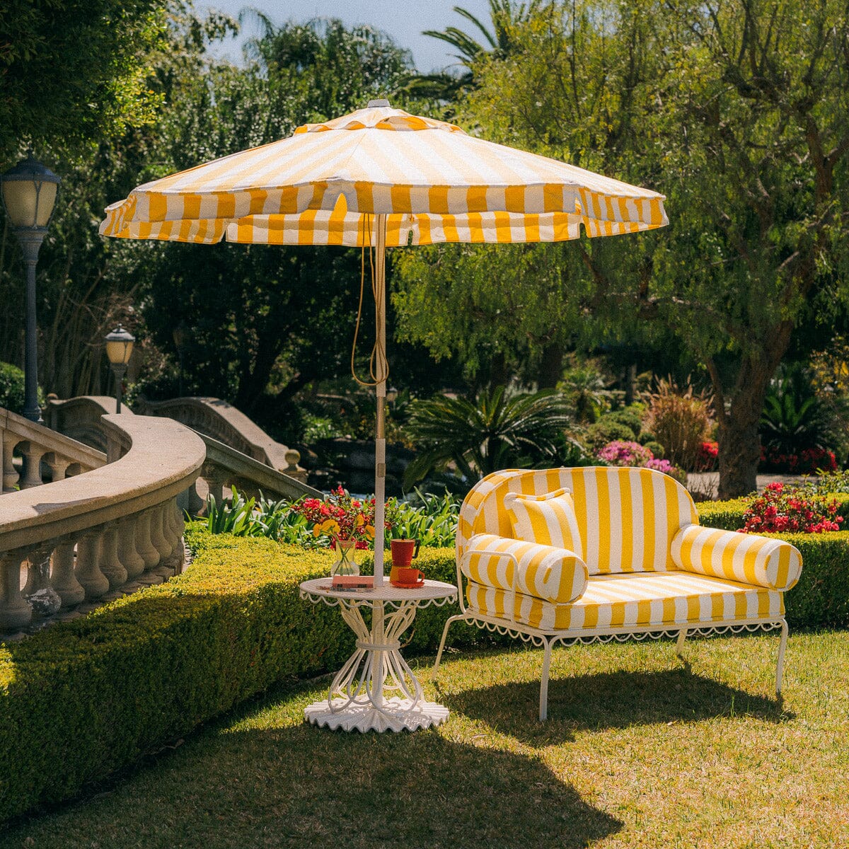 The Al Fresco Love Seat in Crew Mimosa Yellow Stripe | Antique White Frame Bundle Business & Pleasure Co. 