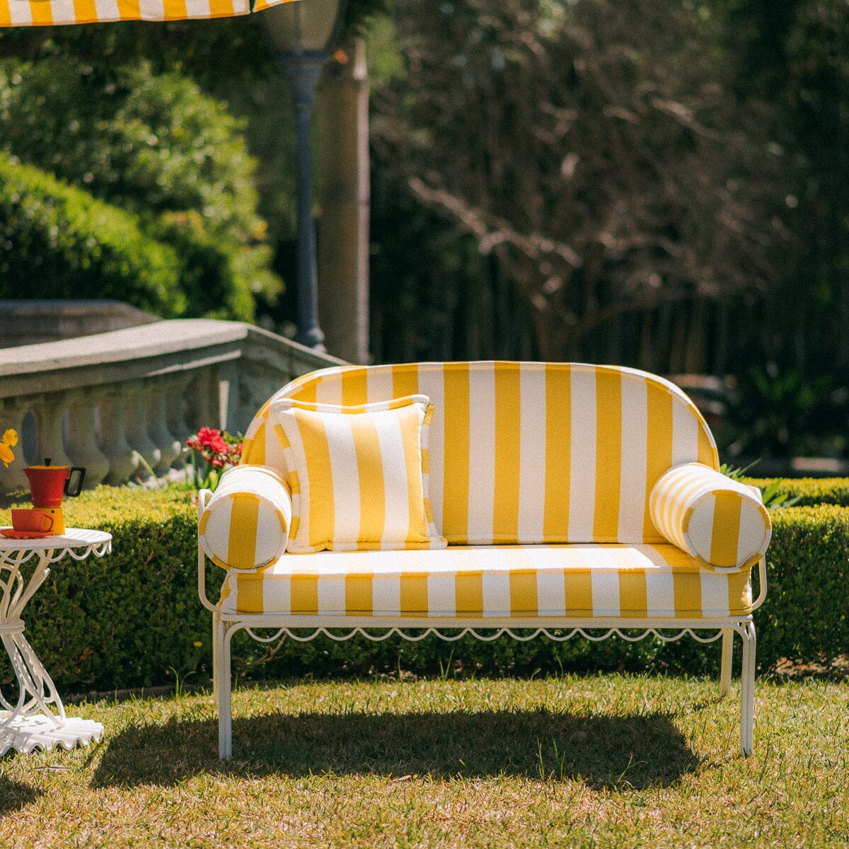 The Al Fresco Love Seat in Crew Mimosa Yellow Stripe | Antique White Frame Bundle Business & Pleasure Co. 