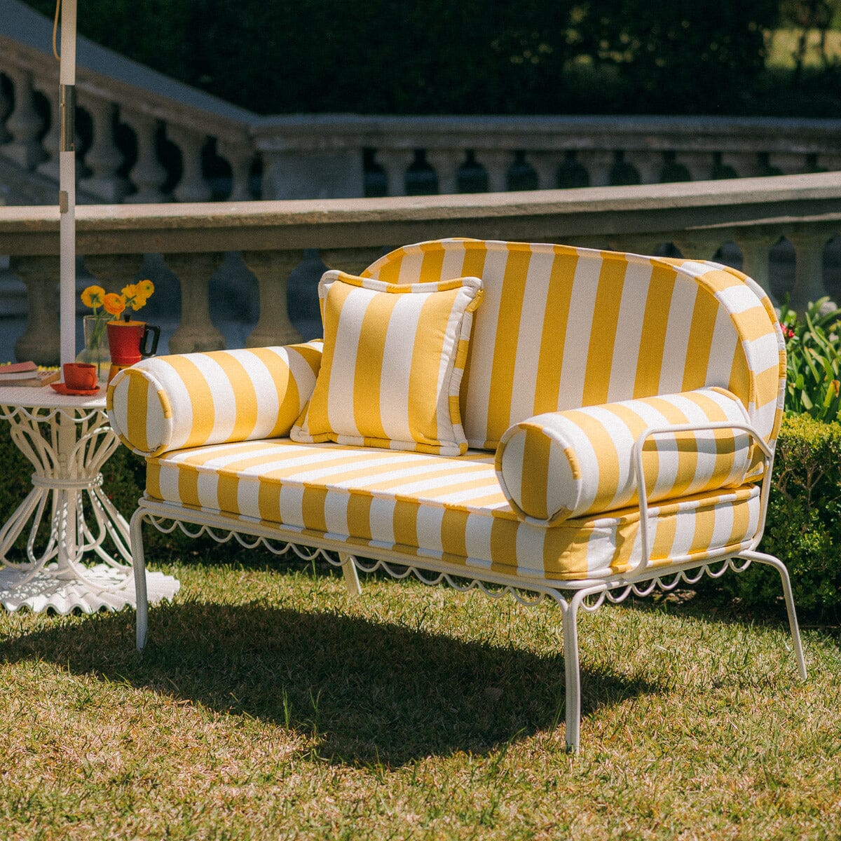 The Al Fresco Love Seat in Crew Mimosa Yellow Stripe | Antique White Frame Bundle Business & Pleasure Co. 