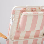 Pink and white striped beach chair back detail showing cooler pouch with a white background
