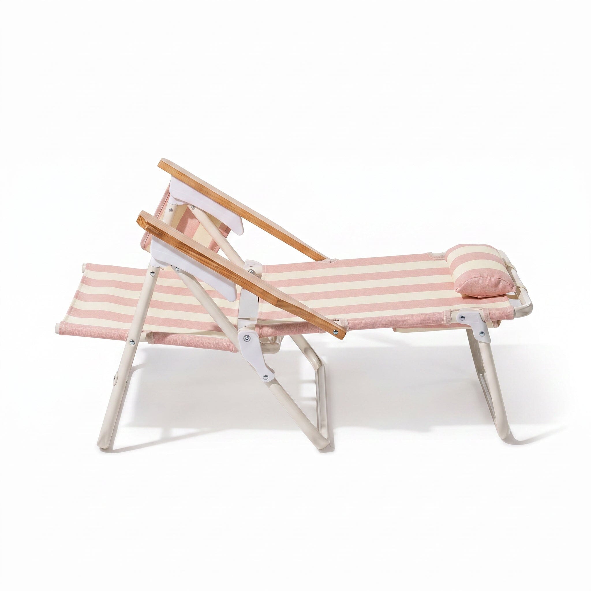 Pink and white striped lounge chair with wooden armrests on a white background