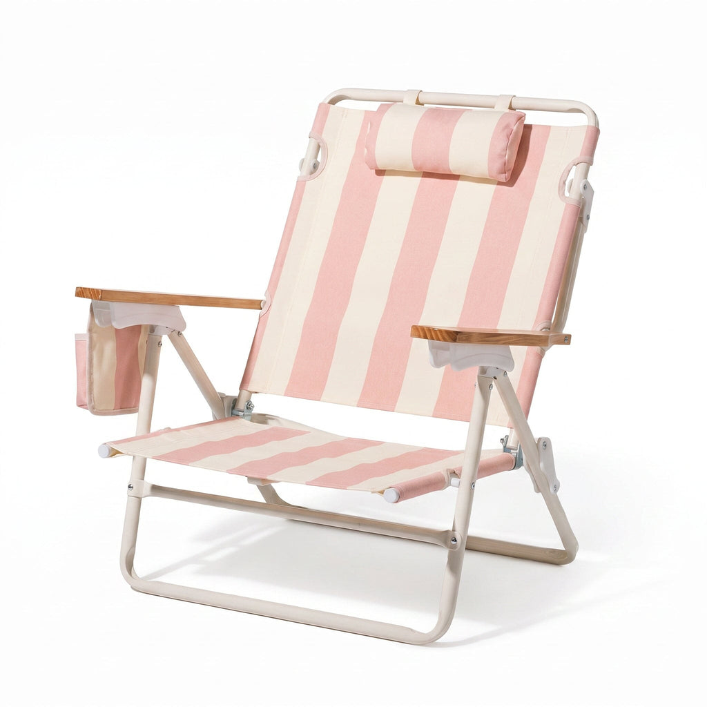 Pink and white striped beach chair with wooden armrests on a white background