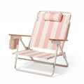 Pink and white striped beach chair with wooden armrests on a white background
