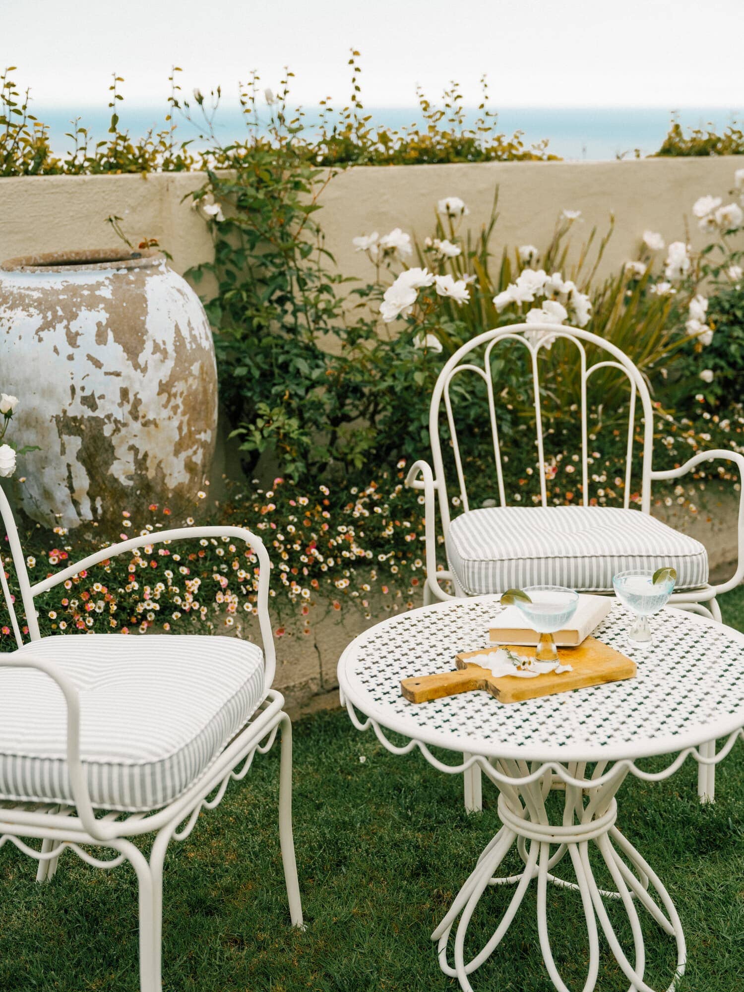 Sage al fresco cushions on chairs in a garden