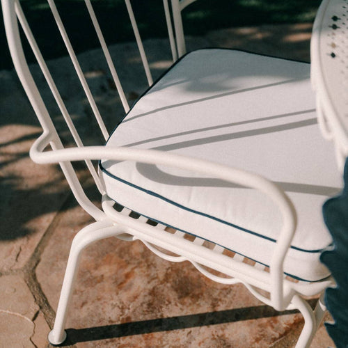 White seat cushion on a seat in the garden