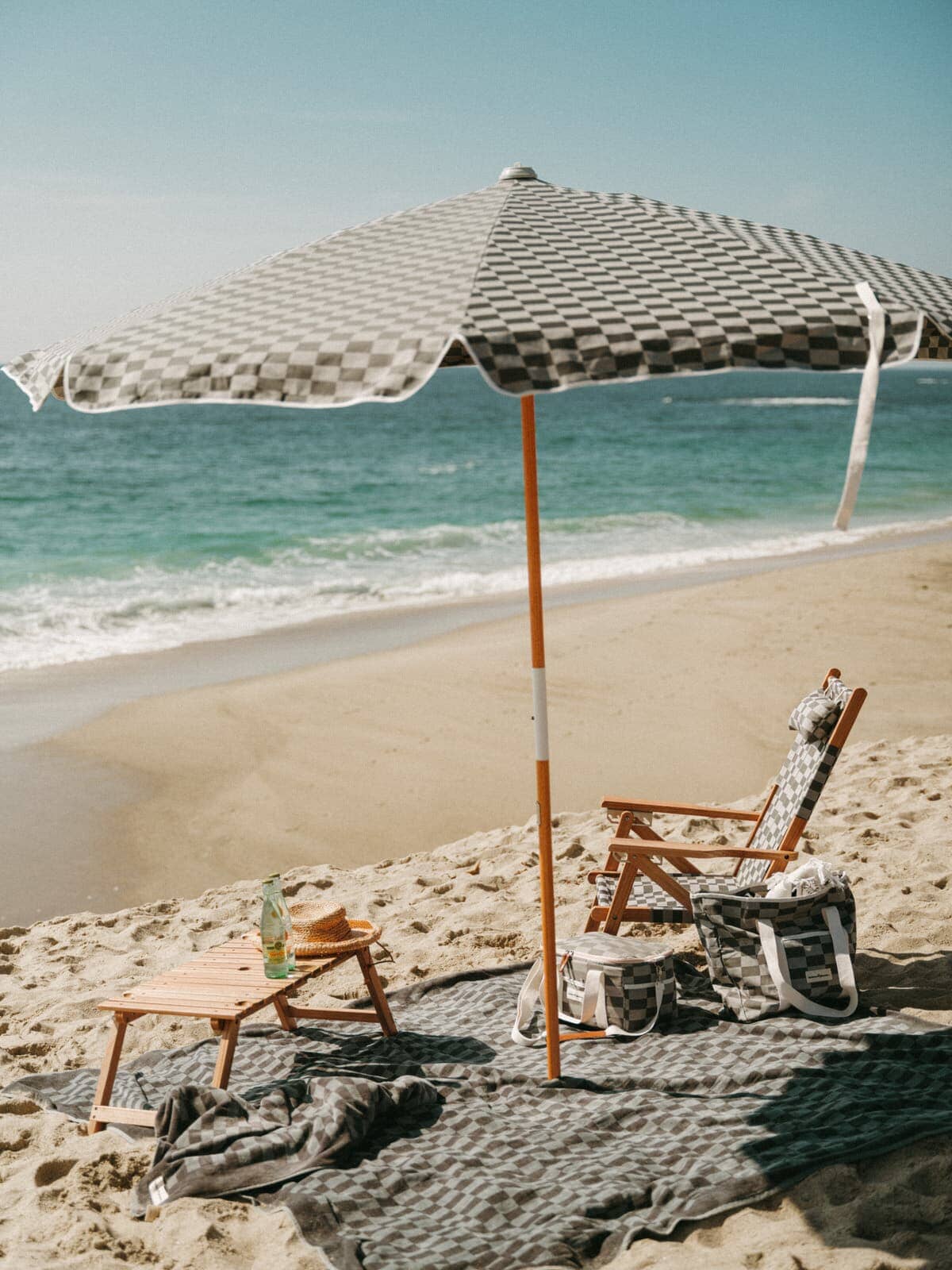 green check amalfi umbrella on the beach with chair and accessories
