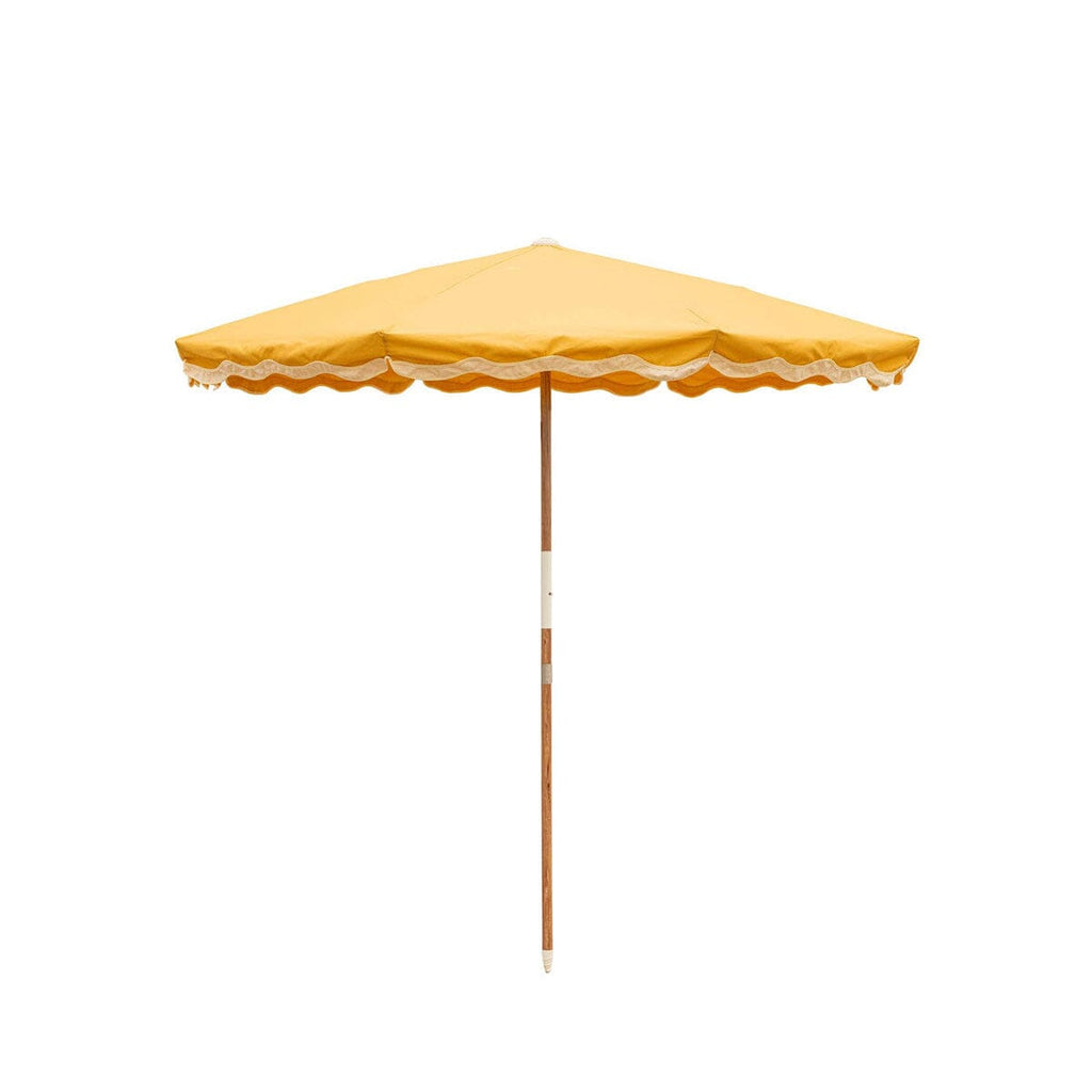 Yellow Beach umbrella with a scalloped edge on a white background