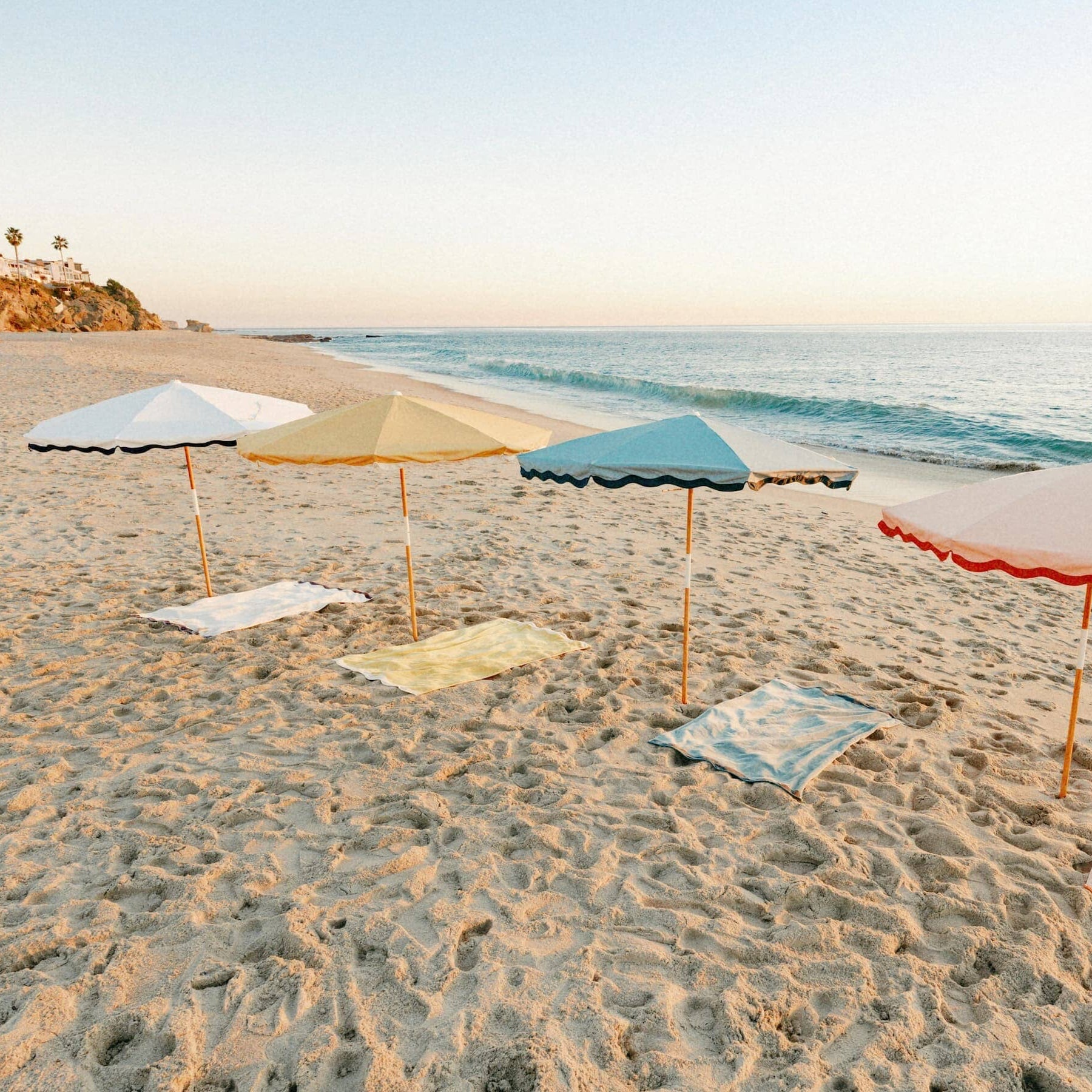 All 4 riviera umbrellas and towels on the beach