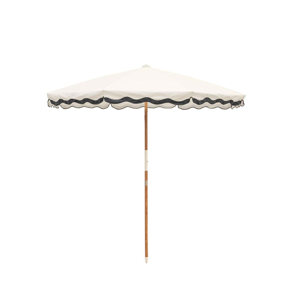 White beach umbrella with dark navy trim on a white background