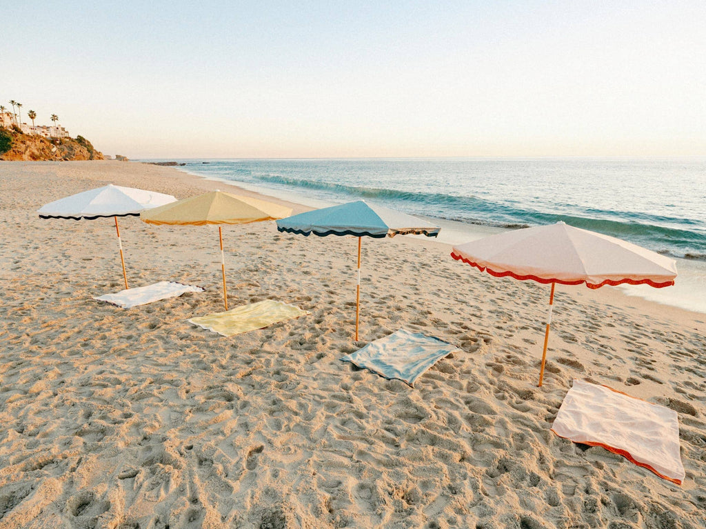 All 4 riviera umbrellas and beach towels on the beach