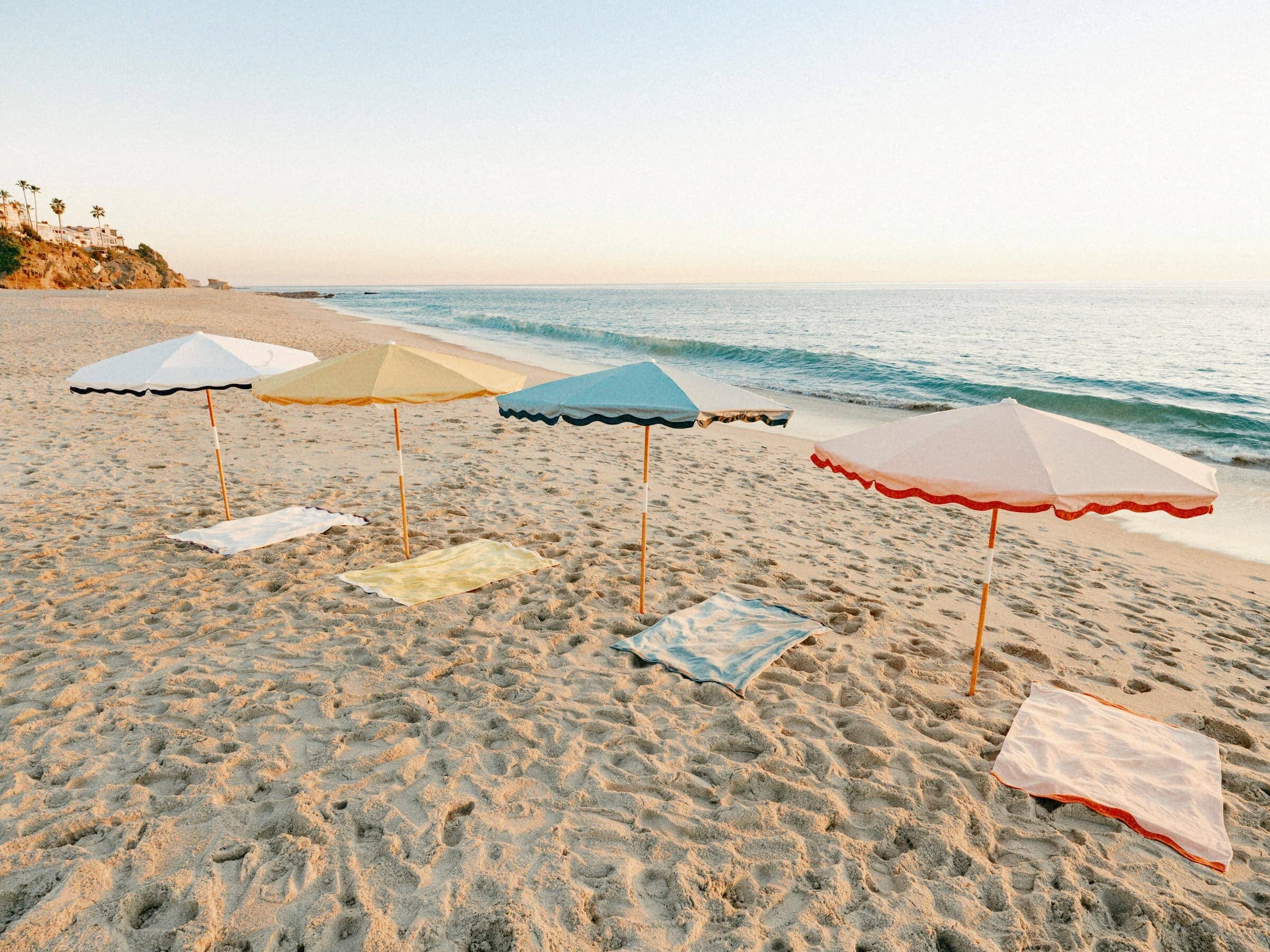 All 4 riviera umbrellas and beach towels on the beach