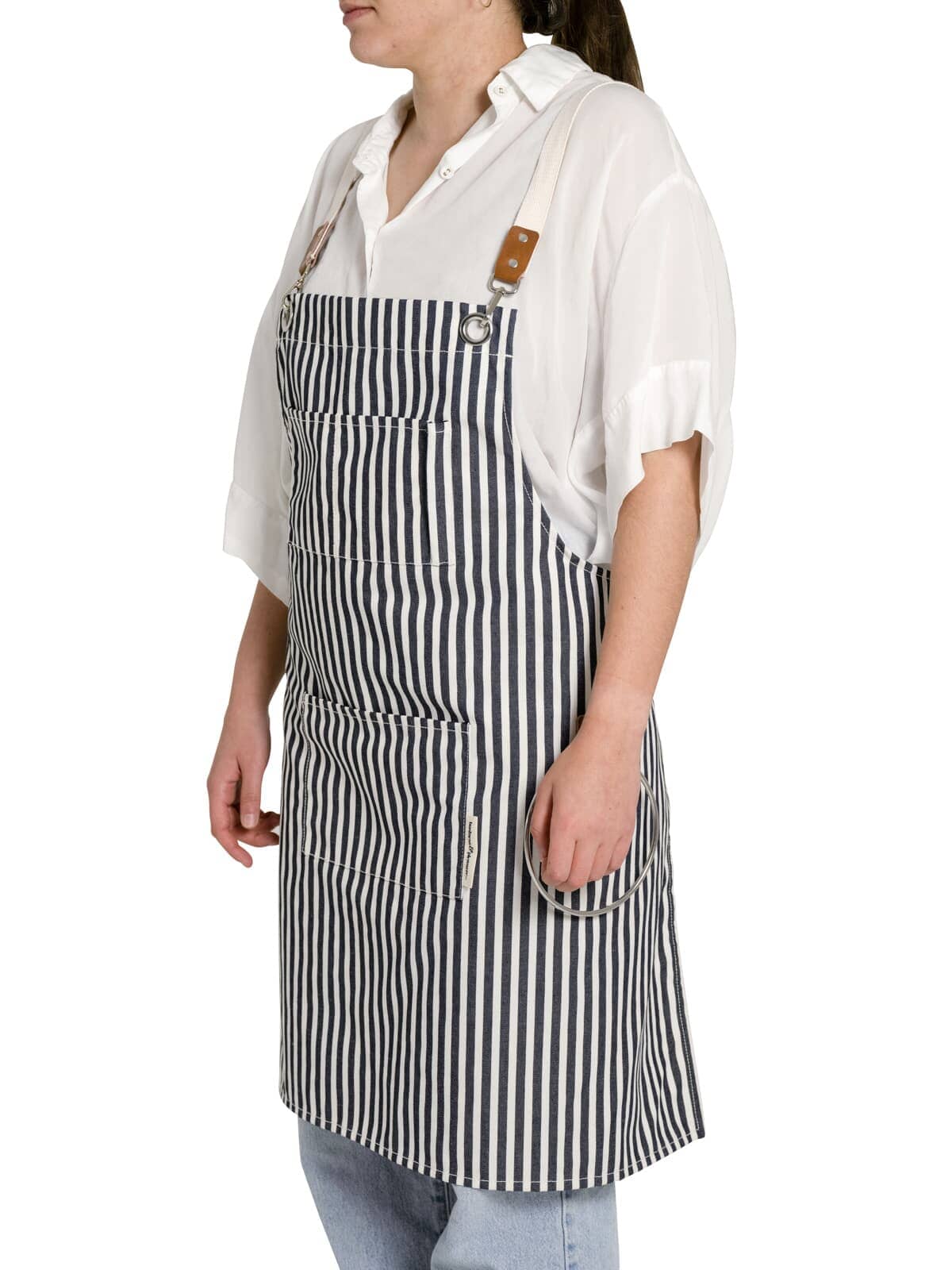 Studio image of navy apron on model