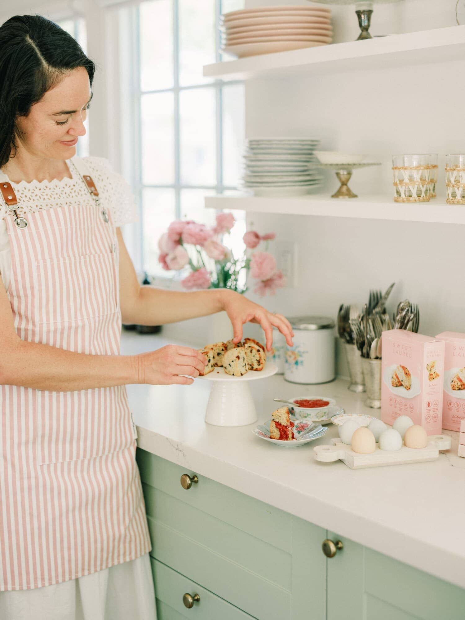 cook in the kitchen wearing pink apron