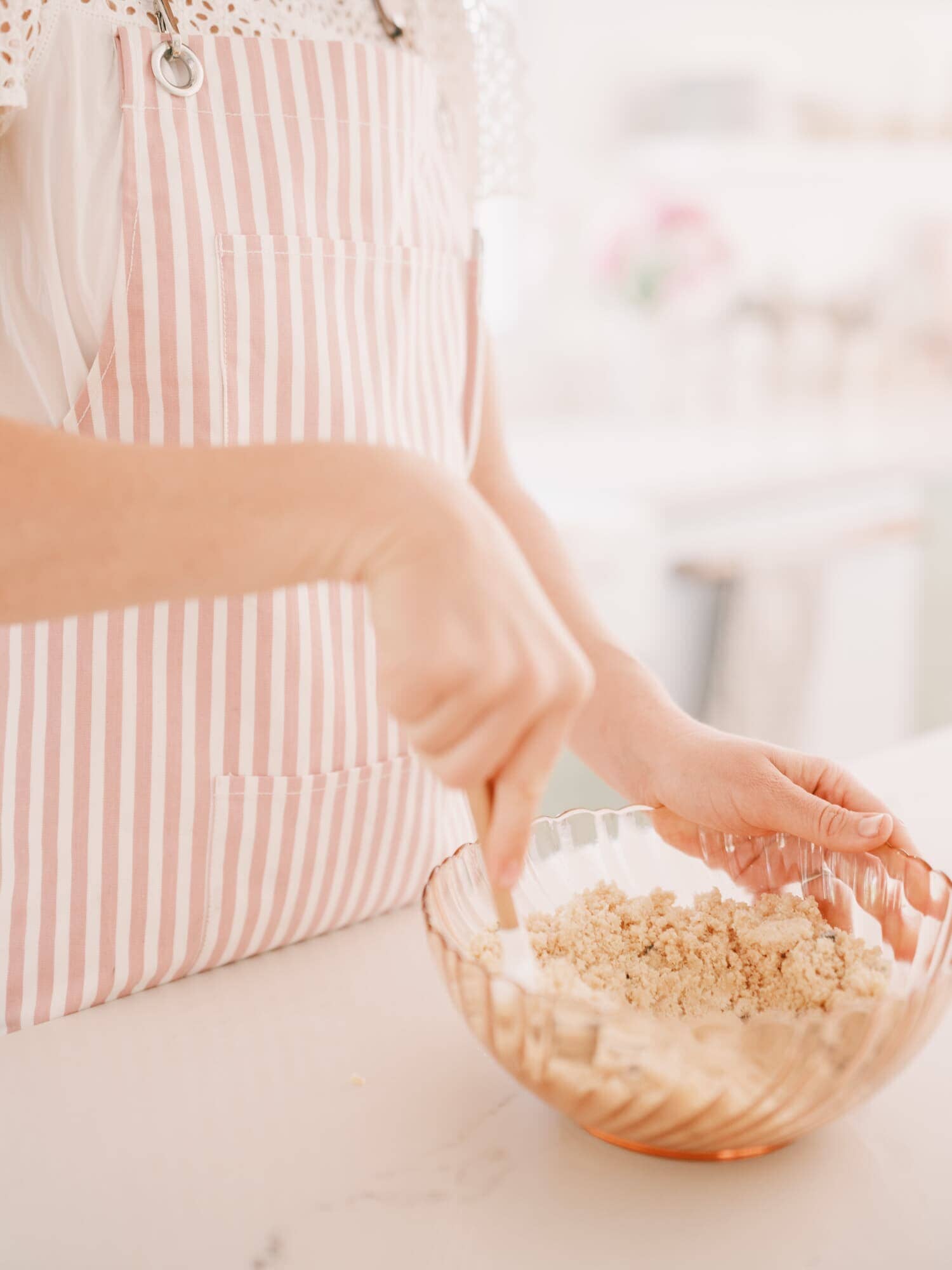 cook in the kitchen wearing pink apron