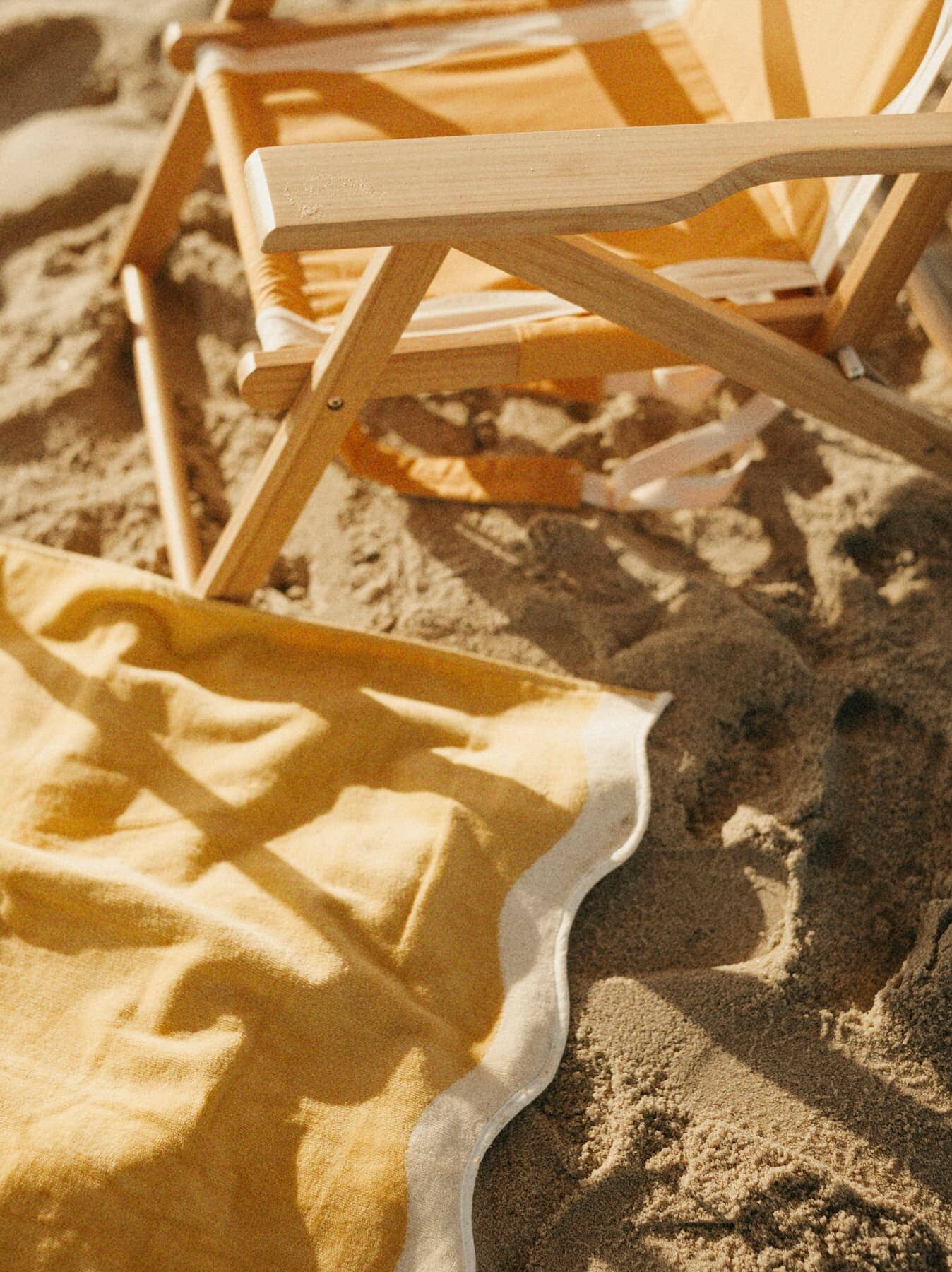 Riviera mimosa towel and chair on the sand