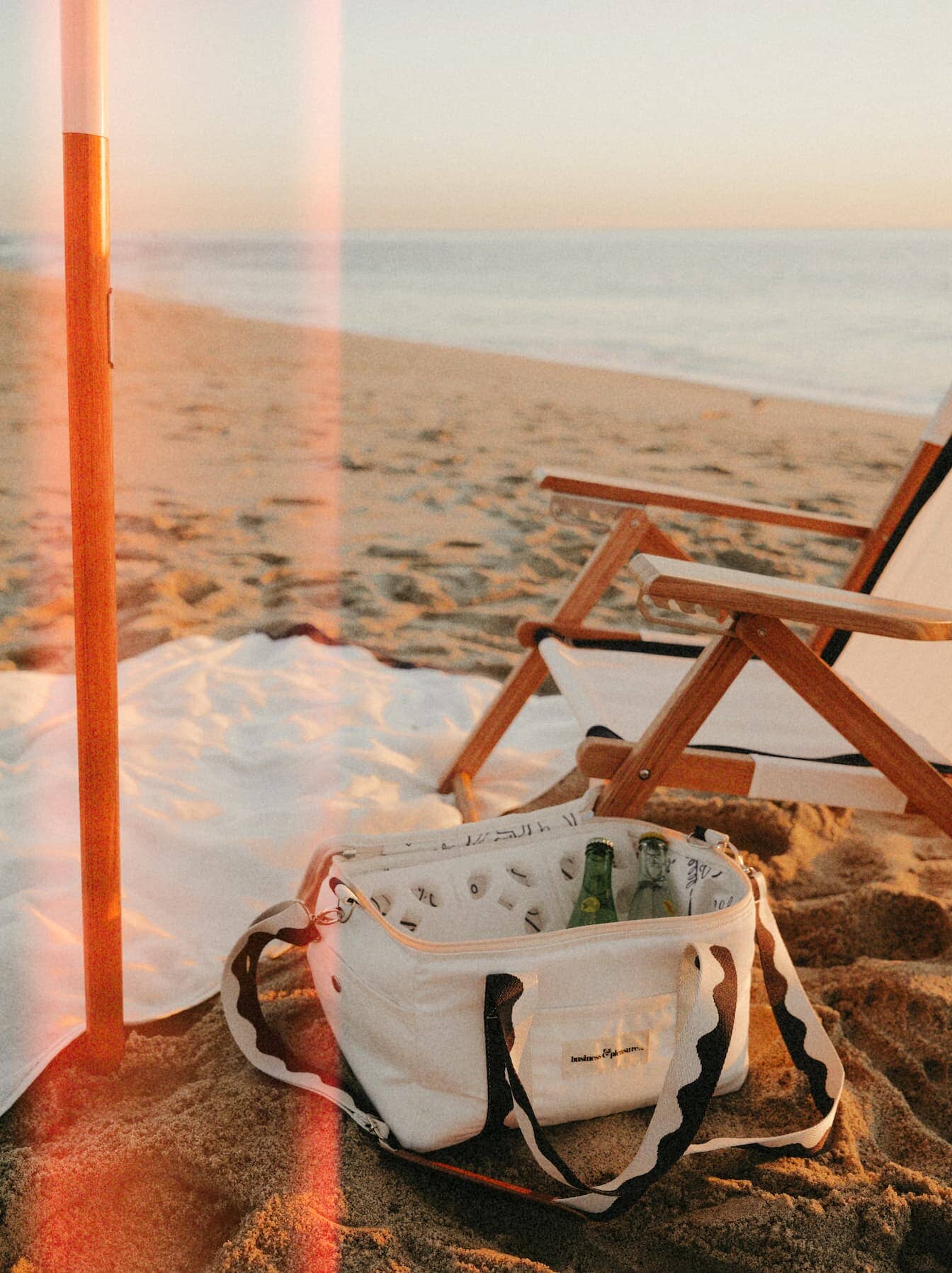 Riviera white chair, cooler and umbrella on the beach