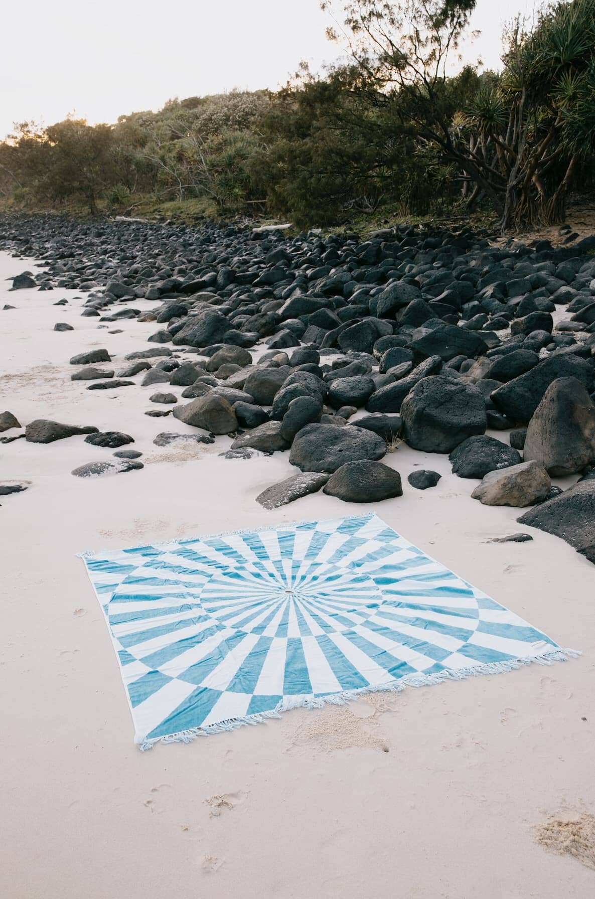 blue spiral beach blanket on the sand