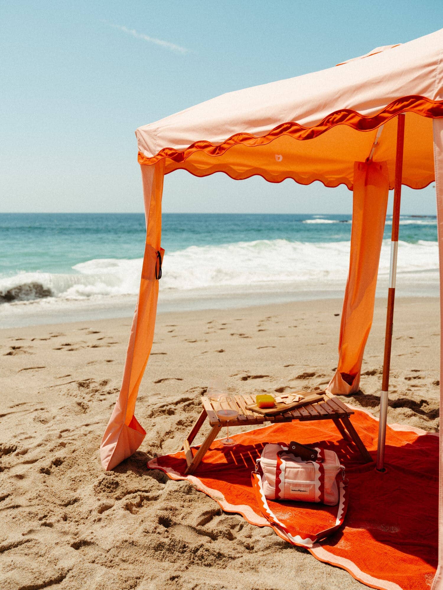 riviera pink cabana, blanket, cooler and table on the beach
