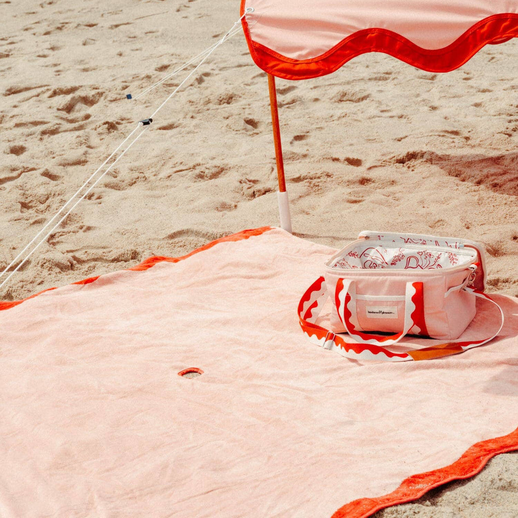 riviera pink tent, blanket and cooler on the beach