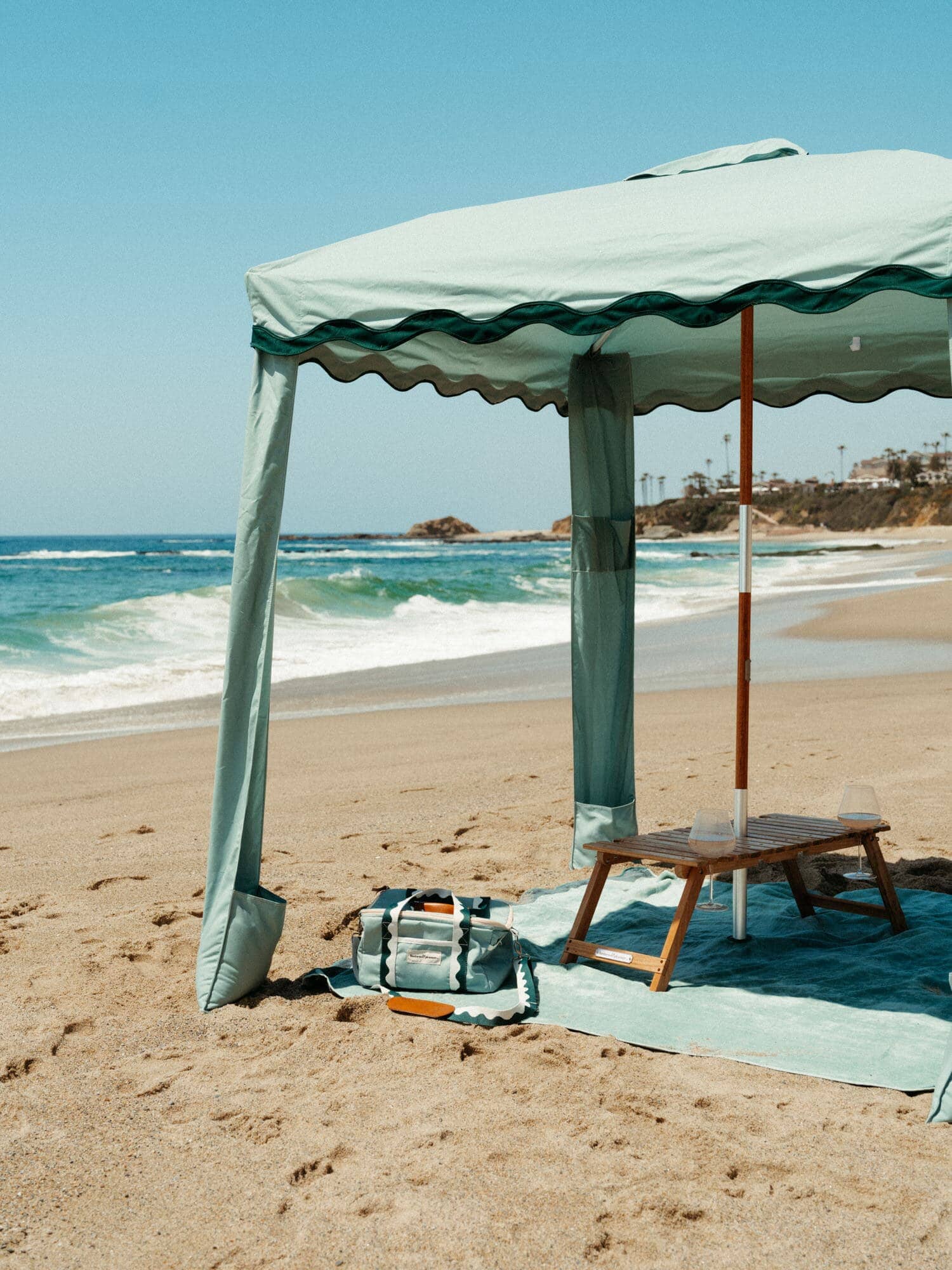 Riviera green cabana on the beach with matching accessories