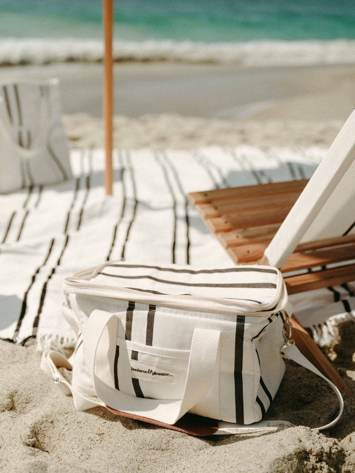 Black two stripe cooler bag on the beach