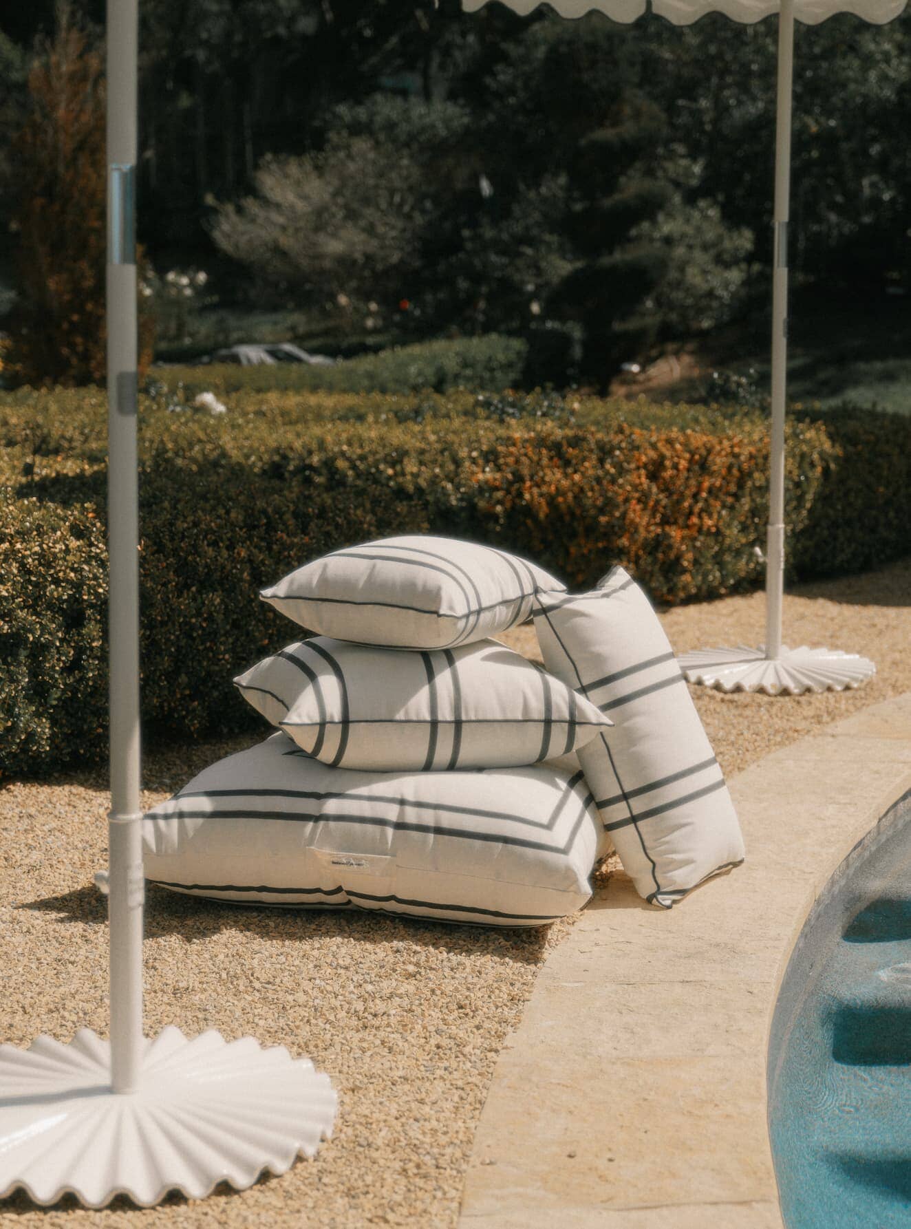 Malibu black stripe cushions next to a pool
