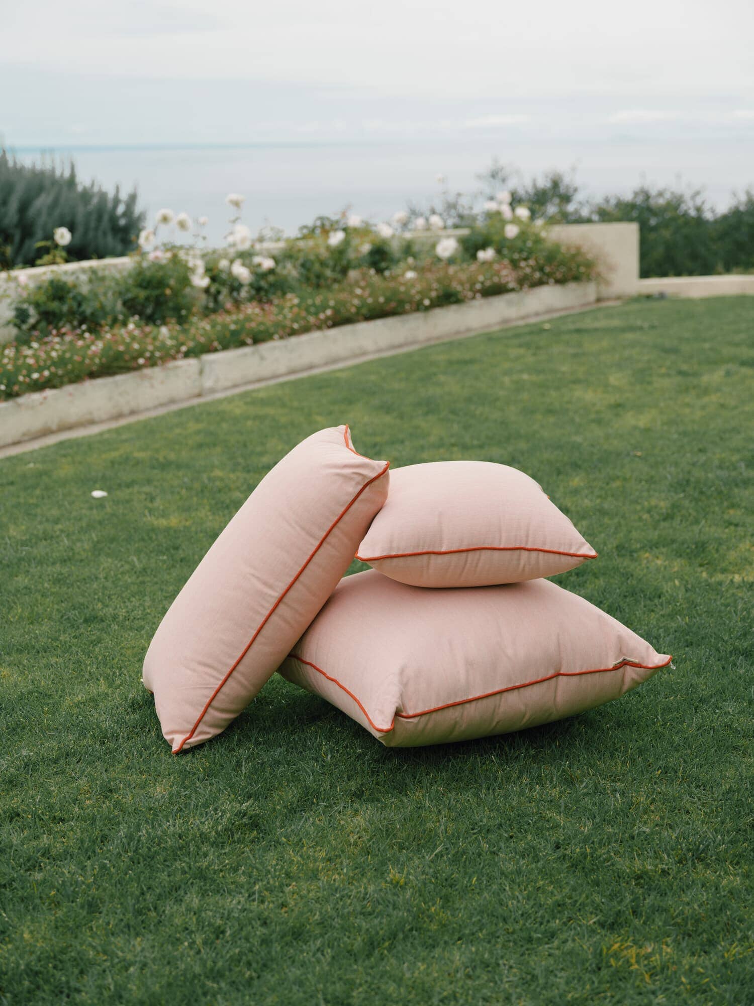 Pink outdoor cushions on grass area