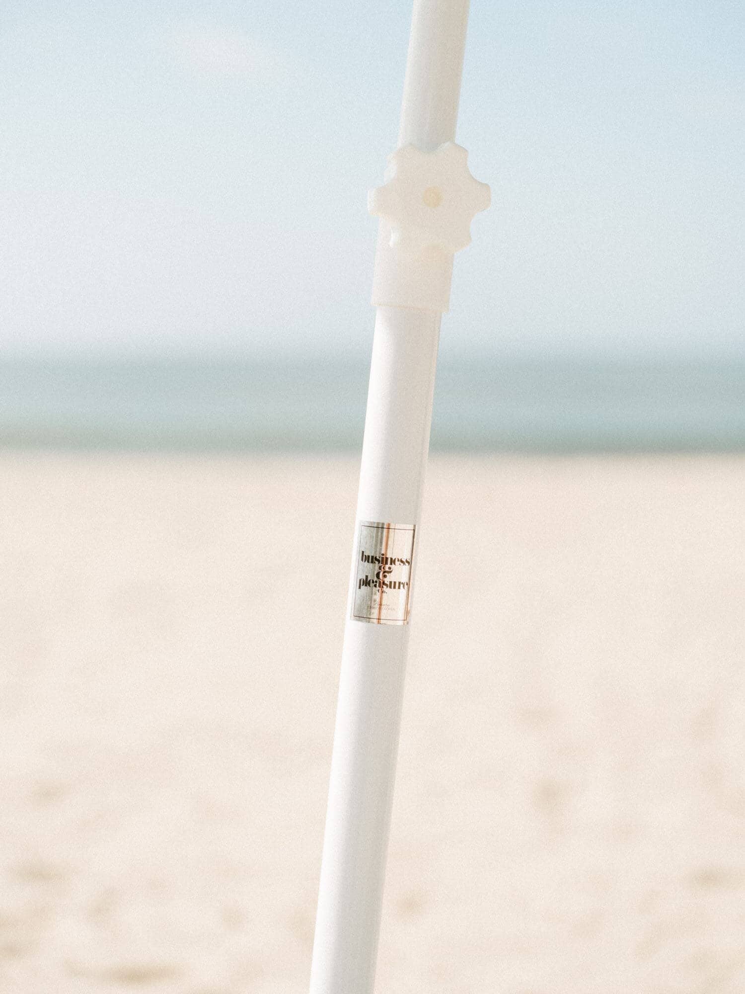 Close up shot of family beach umbrella pole