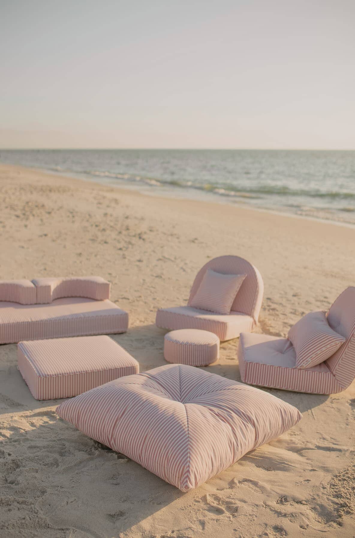pink cushion collection on the beach