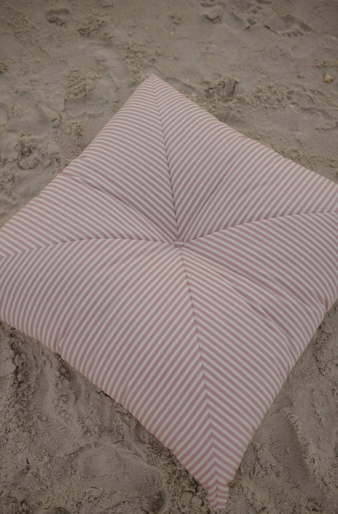 pink floor cushion on the beach