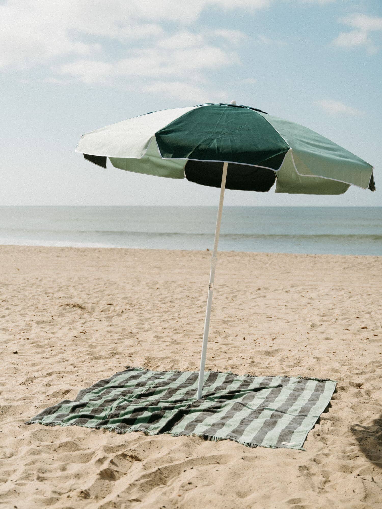&0s panel green blanket with umbrella on the beach