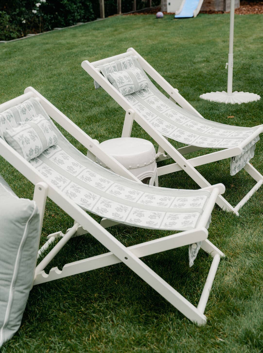 Sling chairs in a garden setting on grass