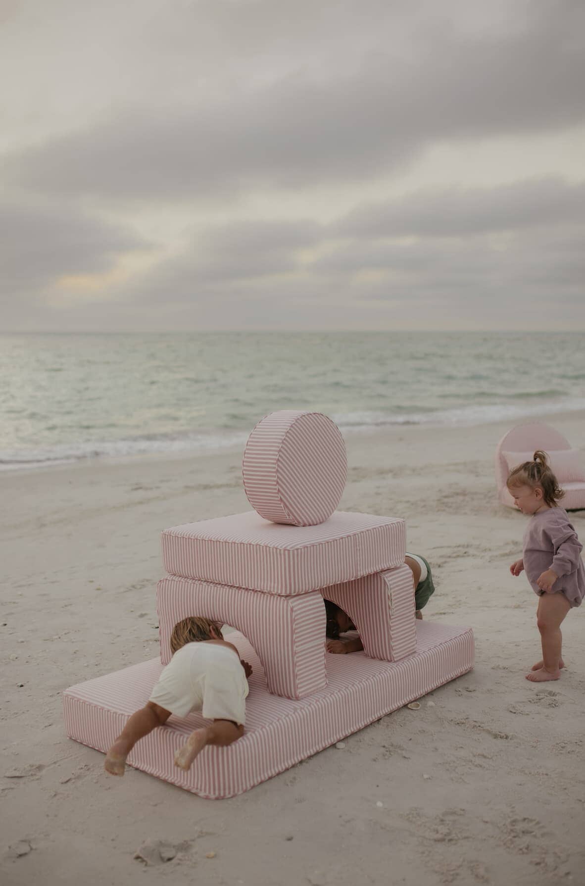 kids playing on modular pillow stack on the beach