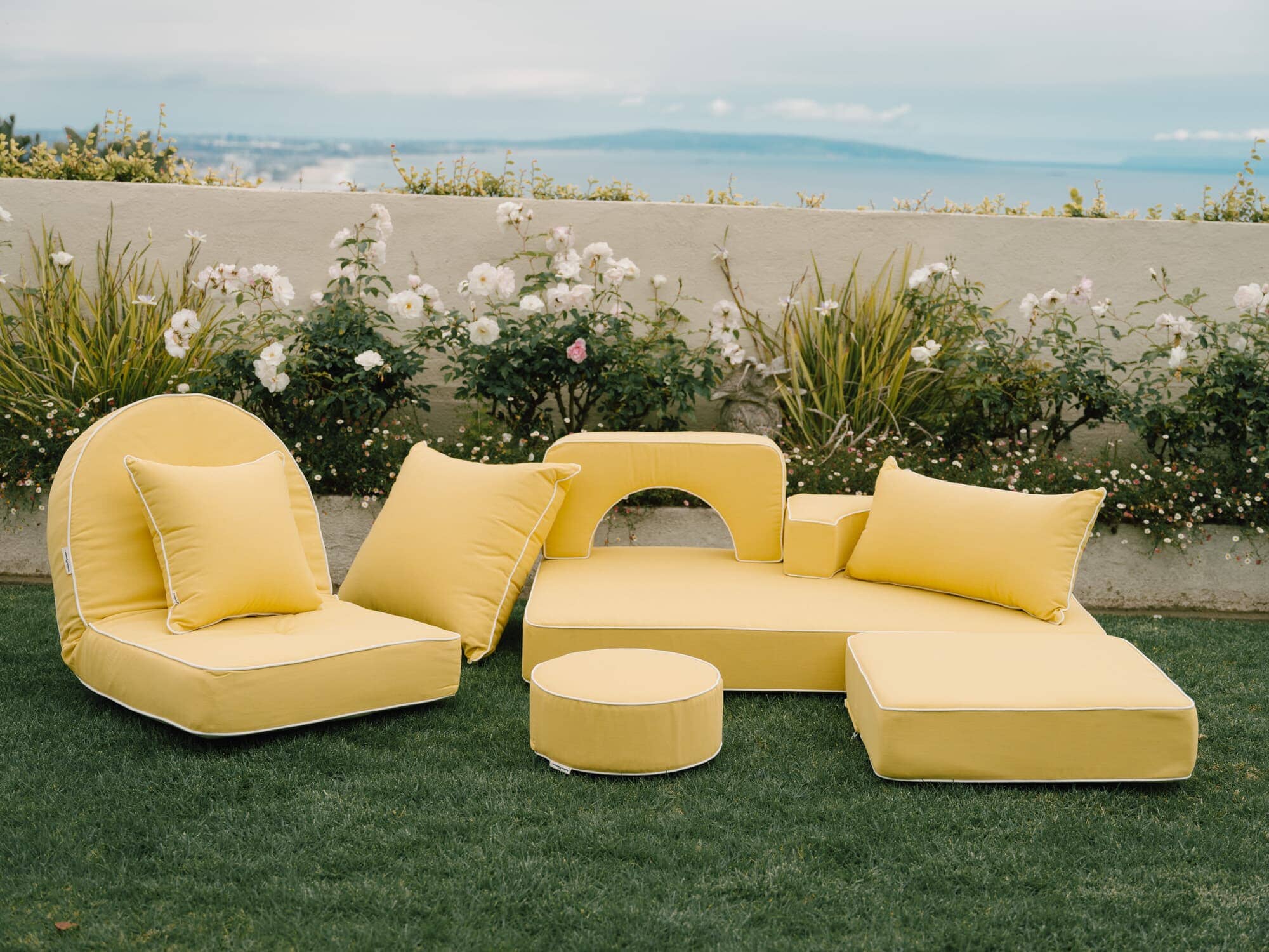Riviera mimosa modular pillow stack in a garden setting
