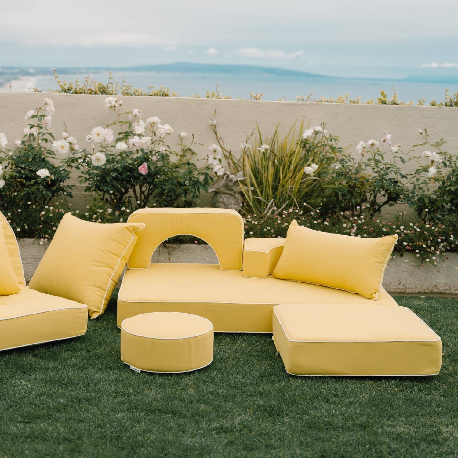 Riviera mimosa modular pillow stack in a garden setting