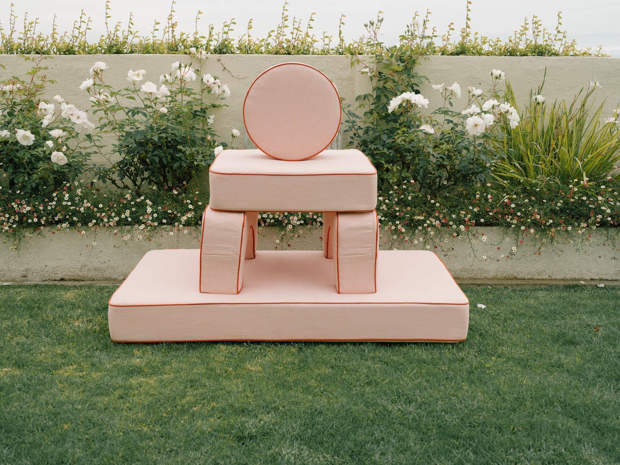 Riviera pink modular pillow stack in a garden setting