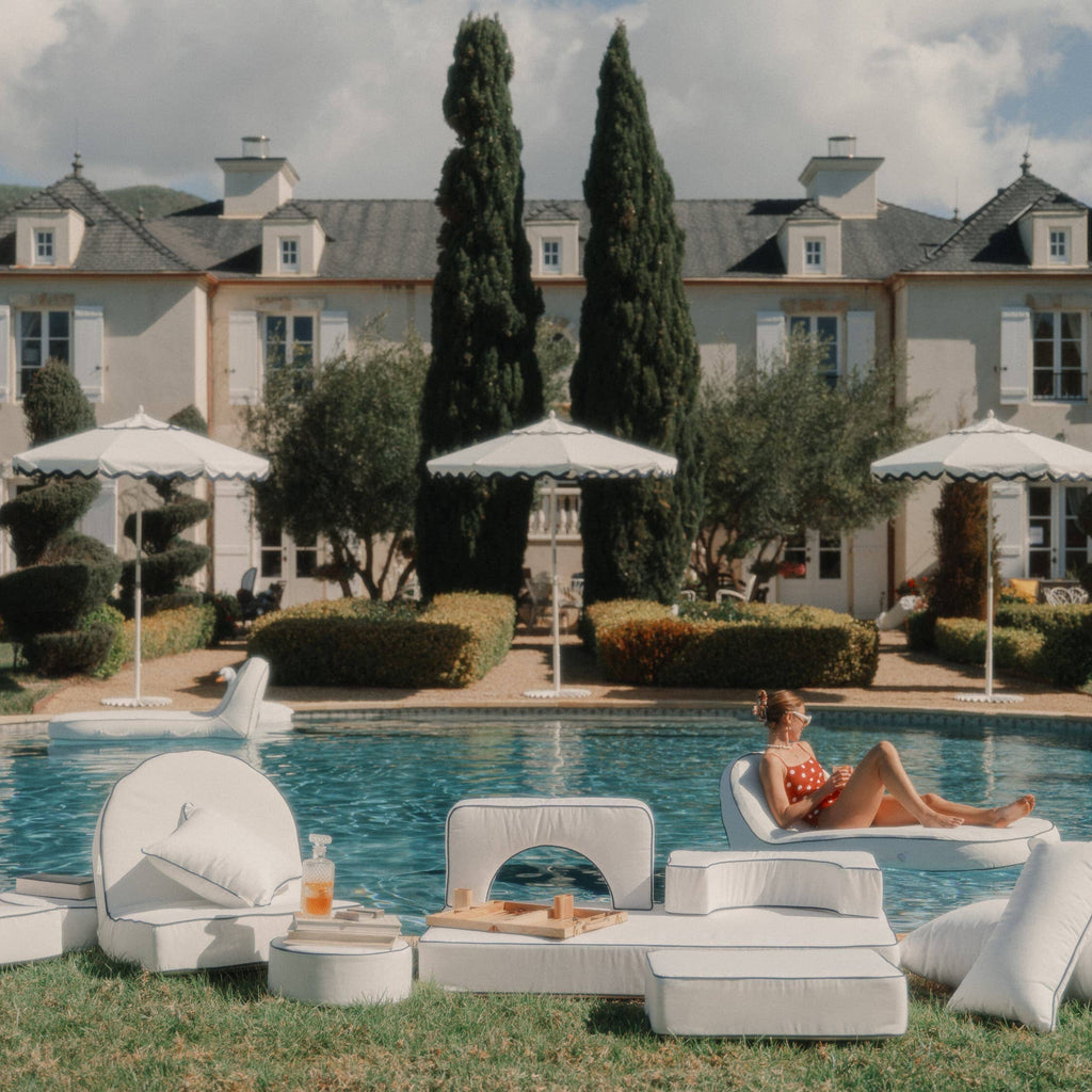 white modular cushions next to a pool