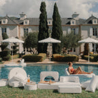 white modular cushions next to a pool