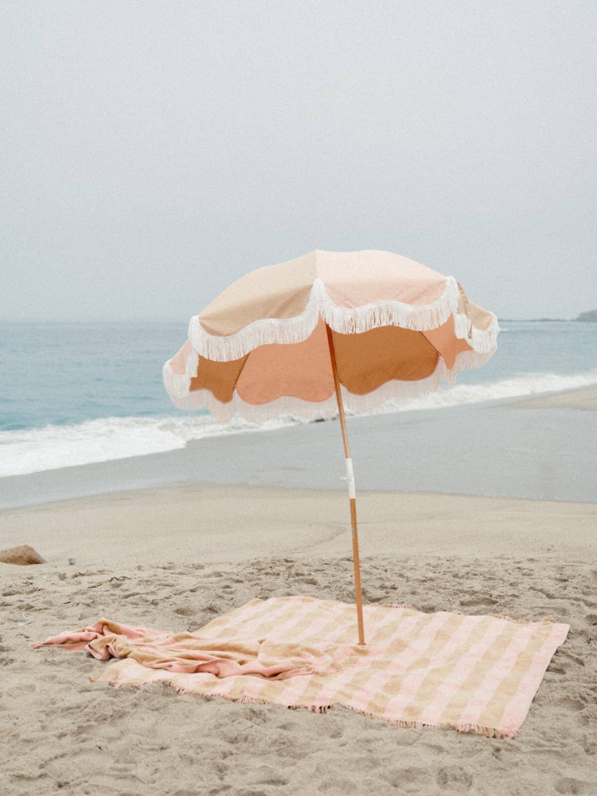 Sand & pink holiday umbrella on the beach