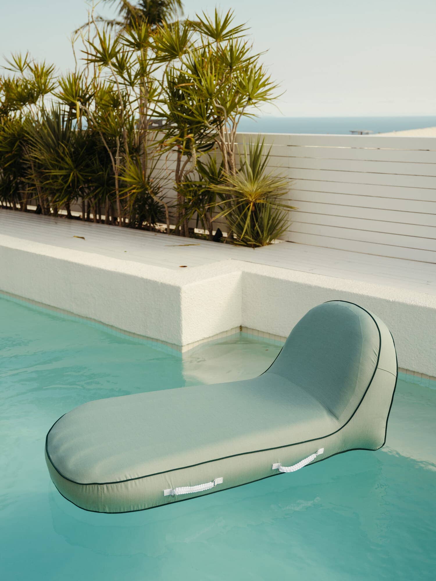 Riviera green pool lounger in a pool