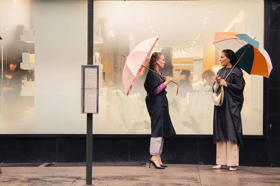 2 women standing in the rain with rain umbrellas
