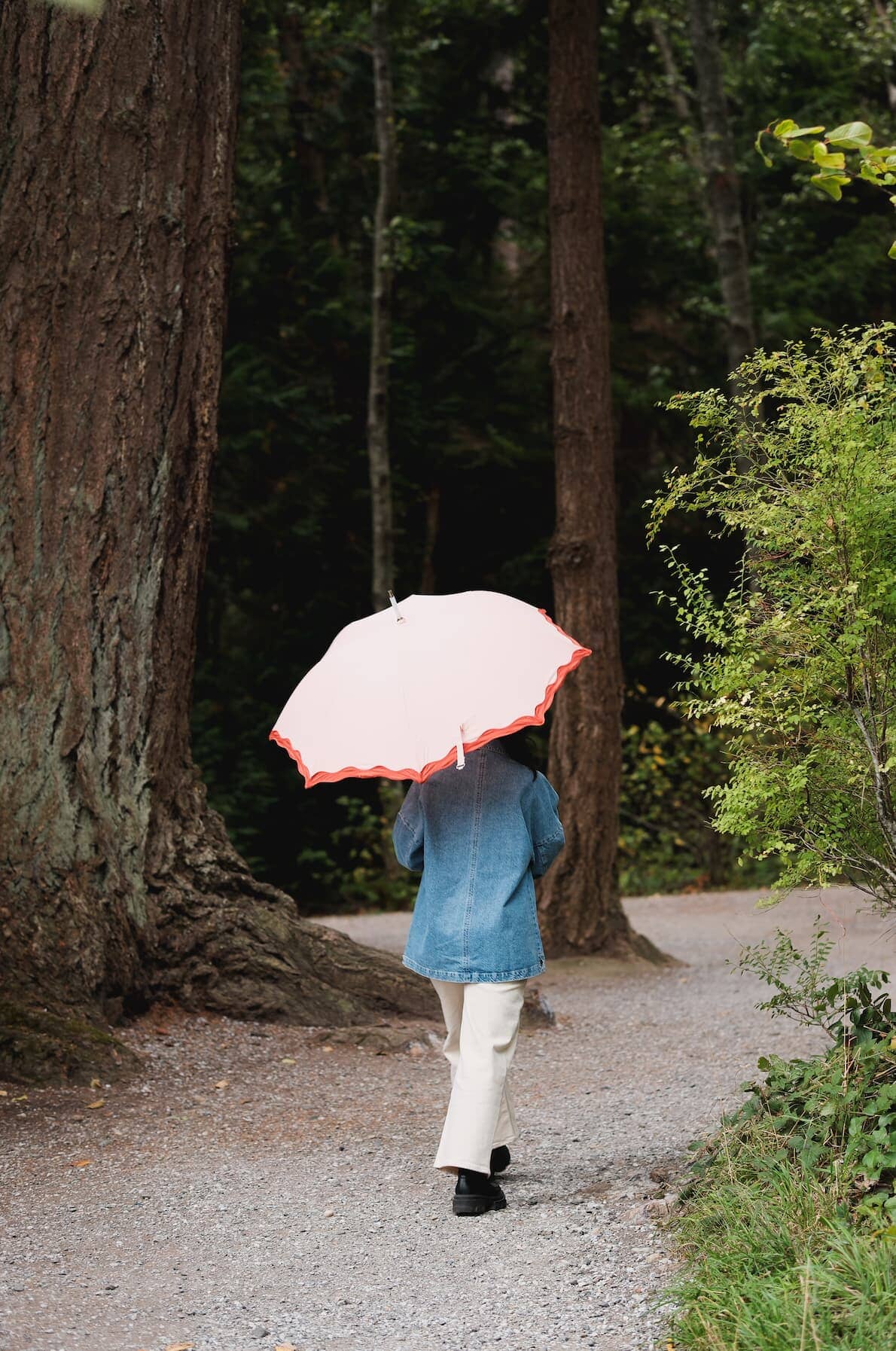 Rivie pink rain umbrella in the woods