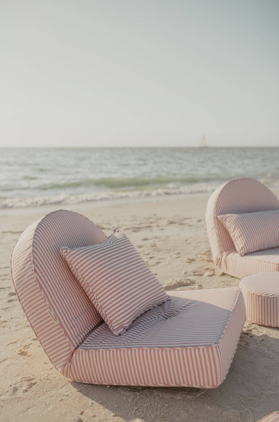 pink reclining loungers on the beach